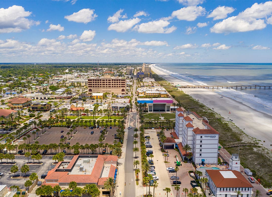 Jacksonville, FL - Beautiful View of a Strip of Beach as the Clouds Pass by an the Water is Crashing Into the Beach